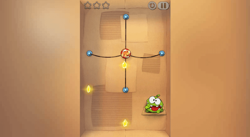 A still from Cut the Rope where candy is suspended by 4 ropes